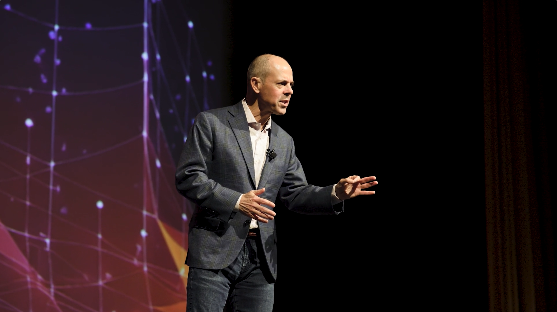 John Austin speaking on stage